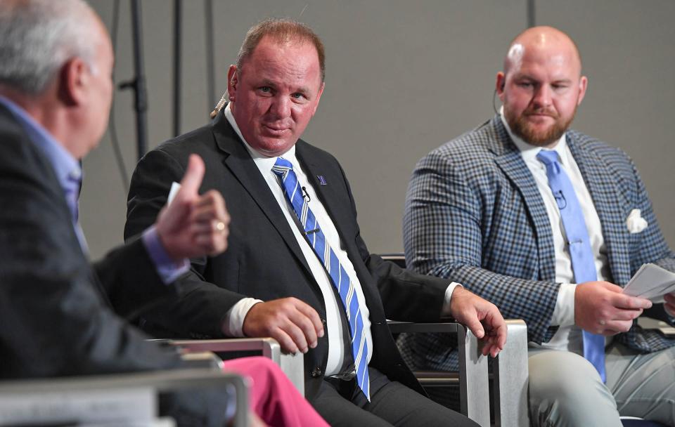 ACC Network personality Mark Packer, left, gives a thumbs up to Duke University Head Coach Mike Elko near Eric Mac Lain, studio analyst on The Huddle show, during the ACC Kickoff Media Days event in downtown Charlotte, N.C. Wednesday, July 26, 2023.
