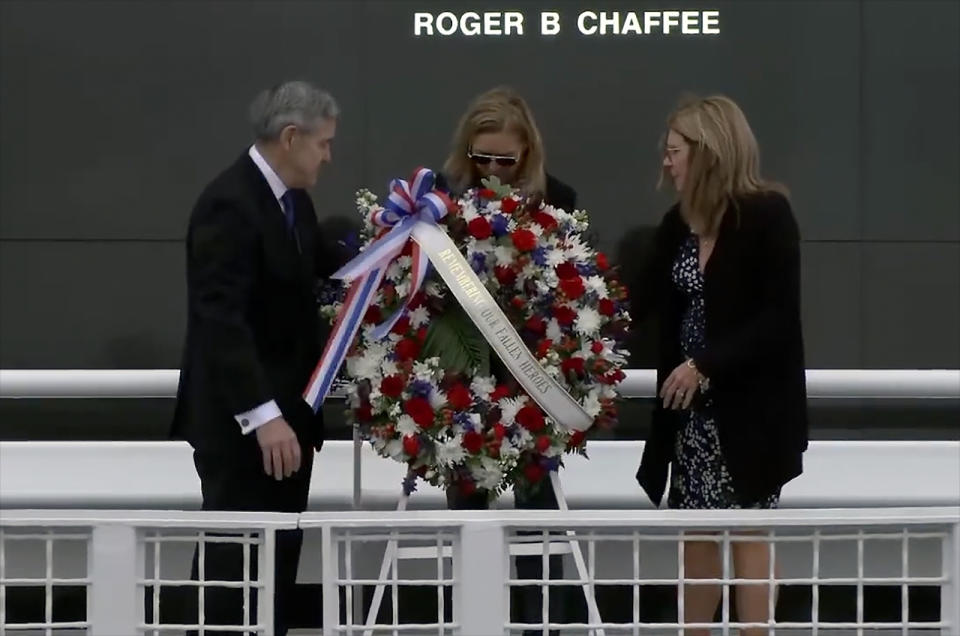 NASA associate administrator Bob Cabana, Kennedy Space Center director Janet Petro and The Astronauts Memorial Foundation chair Sheryl Chaffee position a wreath dedicated to 