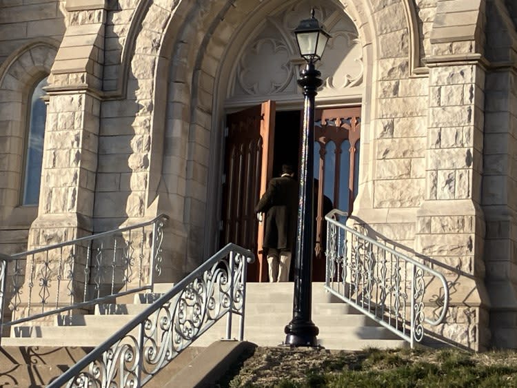 The actor walks inside the main entrance at Sacred Heart in Davenport.