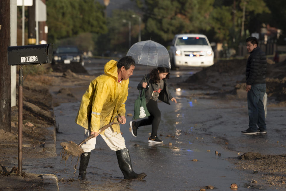 A resident shovels mud in a Los Angeles neighborhood.