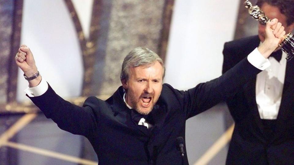 Director James Cameron raises his Oscar after winning in the Best Director Category during the 70th Academy Awards at Shrine Auditorium 23 March. Cameron won for his movie "Titanic."    (ELECTRONIC IMAGE)   AFP PHOTO/Timothy A. Clary (Photo by TIMOTHY A. CLARY / AFP) (Photo by TIMOTHY A. CLARY/AFP via Getty Images)