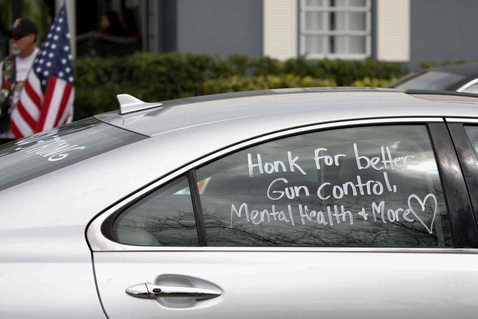 <p>A car with a message in support of gun control written on the window drives past the funeral service for Marjory Stoneman Douglas High School student Peter Wang in Coral Springs, Fla., Feb. 20, 2018. (Photo: Carlos Garcia Rawlins/Reuters) </p>