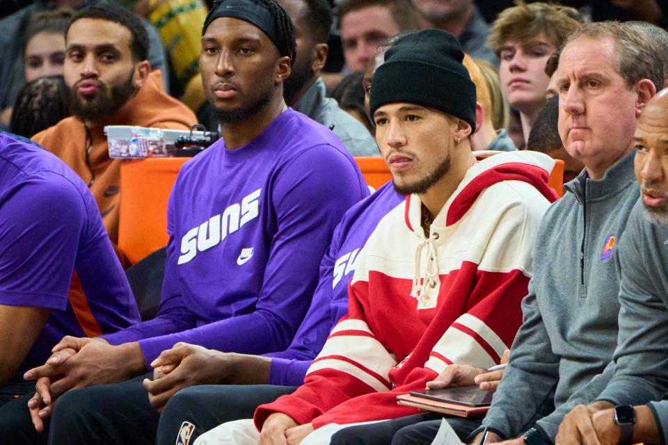 Phoenix Suns guard Devin Booker sits on the bench after being declared out for the game against the Los Angeles Lakers due to groin soreness at Footprint Center on Monday, Dec. 19, 2022.