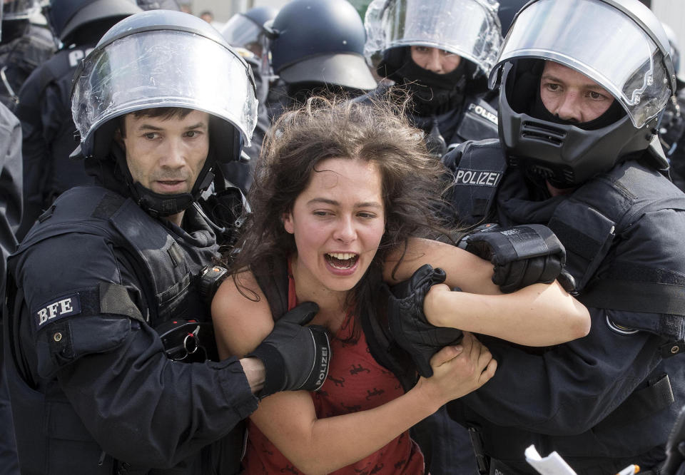 <p>A protester is detained by German police officers during the G-20 summit in Hamburg, Germany, July 7, 2017. (Photo: Massimo Percossi/EPA/REX/Shutterstock) </p>