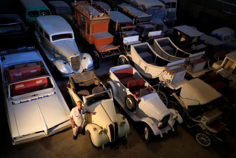 Sayed Sima, a 70-years-old Egyptian collector of vintage cars, stands next to a British Standard Flying Eight Tourer - 1948 automobile in his store, in the Giza suburb of Abu Rawash