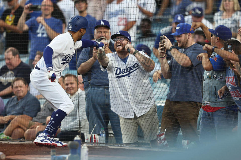 Mookie Betts #50 of the Los Angeles Dodgers celebrates with fans after hitting a solo home run against the Oakland Athletics during the second inning of a game at Dodger Stadium on August 02, 2023 in Los Angeles, California. / Credit: Getty Images