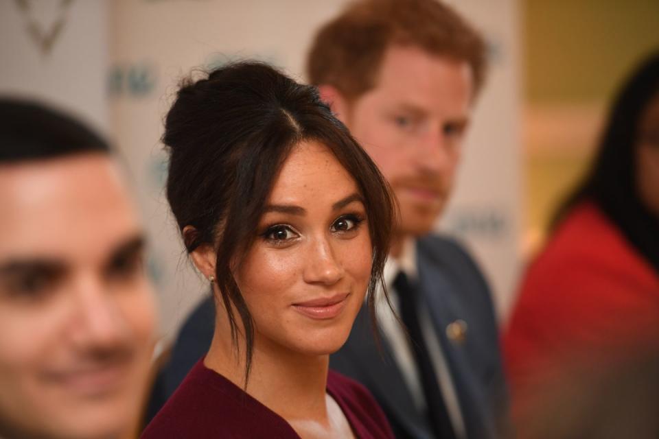 Meghan with a retro beehive and her signature tendrils, 2019