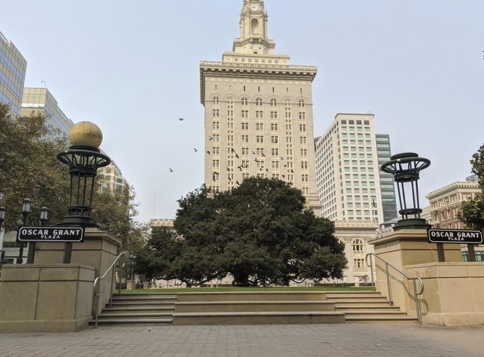 This Oct. 1, 2020, photo shows an empty plaza in front of City Hall in downtown Oakland, Calif. As office workers continue to stay home during the pandemic, cities that were in the middle of bustling downtown comebacks are feeling a lot of uncertainty. (AP Photo/Michael Liedtke)