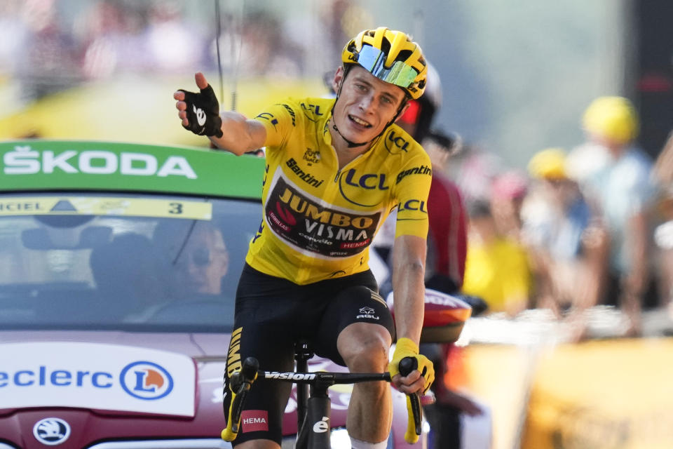 FILE - Stage winner Denmark's Jonas Vingegaard, wearing the overall leader's yellow jersey, celebrates as he crosses the finish line during the eighteenth stage of the Tour de France cycling race, with start in Lourdes and finish in Hautacam, France, on July 21, 2022. Tour de France champion Jonas Vingegaard will be backed by some of the best riders in the world in his bid for a double. Team Jumbo-Visma’s selection of riders for cycling’s biggest race unveiled Monday, June 26, 2023 is a well balanced roster of riders that will offer Vingegaard close protection on the flat, and crucial assistance in high mountains. (AP Photo/Thibault Camus, File)