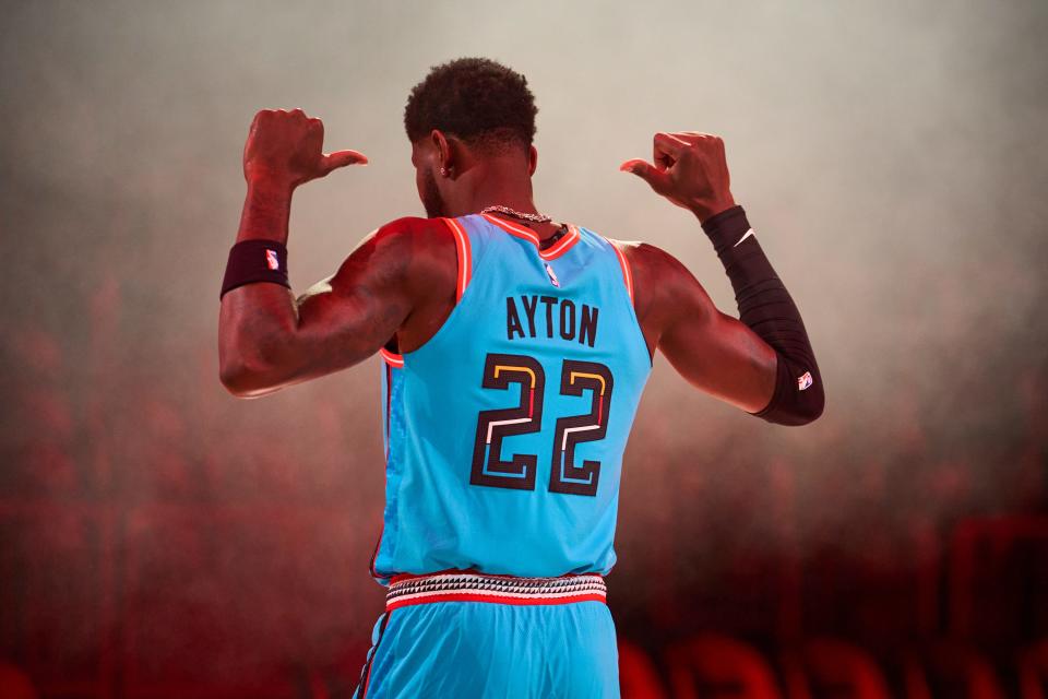 Phoenix Suns center Deandre Ayton flexes for the camera during a marketing shoot for the 2022-2023 City Edition uniform at Footprint Center in Phoenix, Ariz., on Oct. 14, 2022. The City Edition uniform pays tribute to the rich histories and cultures of the state's Tribal Nations and celebrates their shared love of basketball.