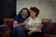 Mazen Jaber and Dona-Maria Nammour, who had a civil marriage in Cyprus earlier this year, laugh as they speak during an interview with The Associated Press at their home in Beirut, Lebanon, Friday, June 3, 2022. In Lebanon, the question of civil marriage is a contentious issue mired in fierce religious and political debates. (AP Photo/Bilal Hussein)