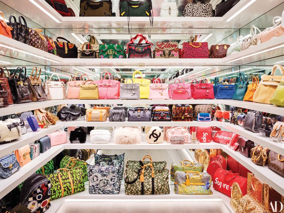 Jenner’s handbag closet features white lacquer shelving.