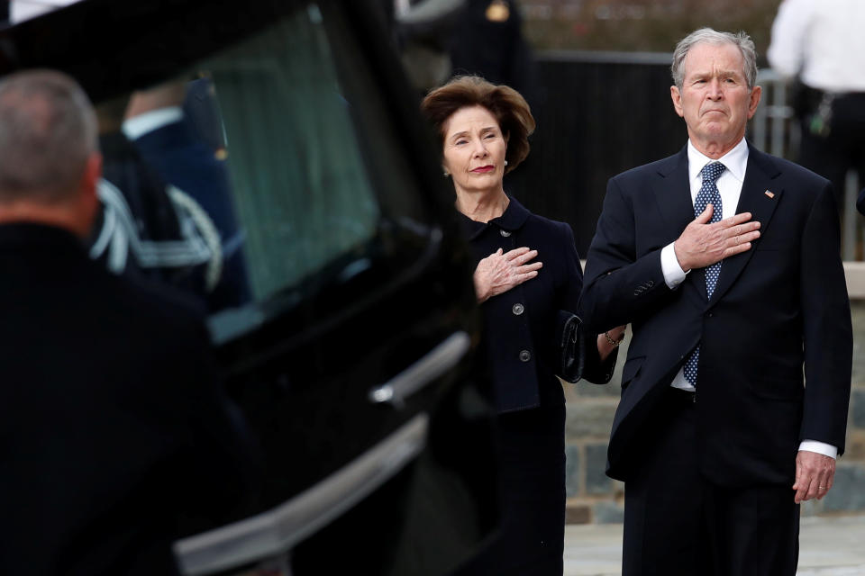 Former President George W. Bush and Laura Bush watch as the flag-draped casket of former President George H.W. Bush is carried by a joint services military honor guard to a State Funeral at the National Cathedral, Wednesday, Dec. 5, 2018, in Washington. (Photo: Alex Brandon/Pool via Reuters)