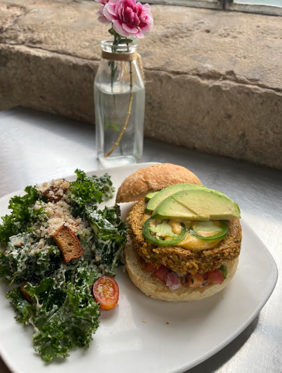 The Nacho Burger from Living Kitchen includes chipotle sunflower seed hummus, avocado, spicy butternut squash queso, pico de gallo and jalapenos. 
