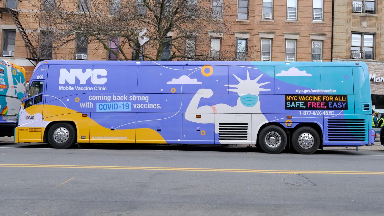 An NYC Mobile Vaccine Clinic bus is seen parked on Seventh Ave. and 54th St. in Brooklyn early Wednesday, April 7, 2021. The bus can give out 150-200 doses of the Johnson & Johnson vaccine a day and will be used to reach the city's most vulnerable populations.