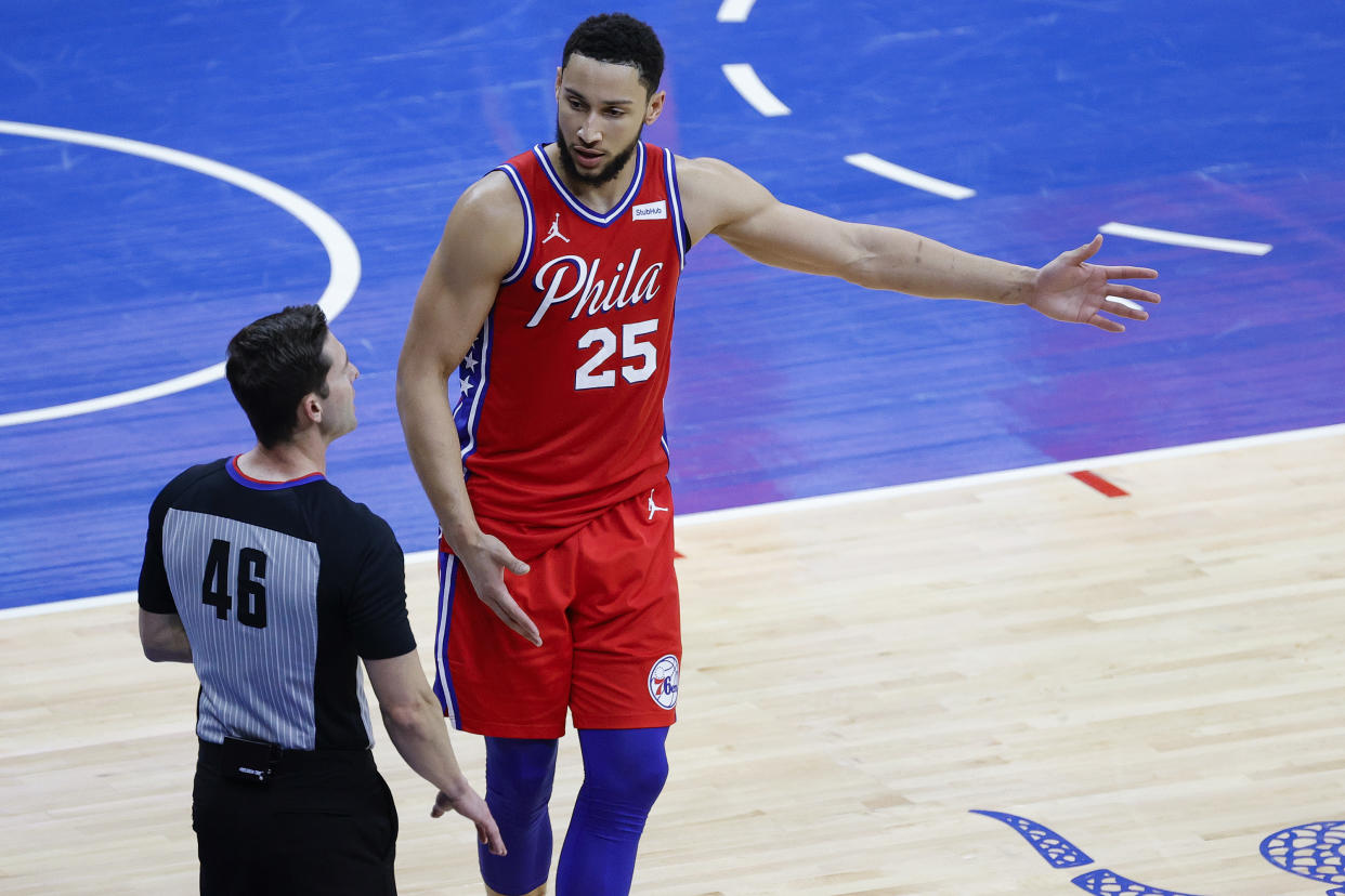 Ben Simmons talks to a ref on the court.