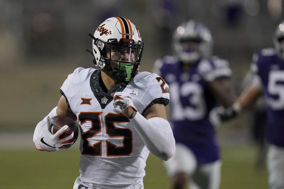 Oklahoma State safety Jason Taylor II (25) runs a recovered fumble 85 yards for a touchdown during the second half of an NCAA college football game against Kansas State in Manhattan, Kan., Saturday, Nov. 7, 2020. (AP Photo/Orlin Wagner)