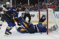 St. Louis Blues' Jordan Binnington (50) stretches out to make a save during the third period in Game 6 of the team's NHL hockey Stanley Cup first-round playoff series against the Minnesota Wild on Thursday, May 12, 2022, in St. Louis. (AP Photo/Michael Thomas)