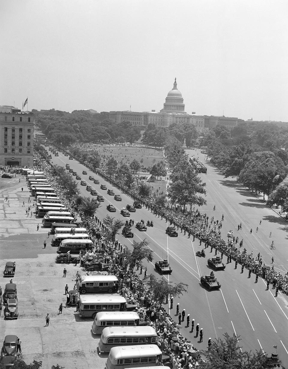 Preceded by rumbling tanks, the welcoming parade for King George VI and Queen Elizabeth is moved through Constitution Avenue in Washington on June 8, 1939. Heavily armed Secret Service men on foot and motorcycle police flanked the car in which the king rode with President Franklin Roosevelt. Soldiers, Marines and sailors stood at attention along the route as the cars passed by, and cheering throngs lined every foot the parade route. (AP Photo)