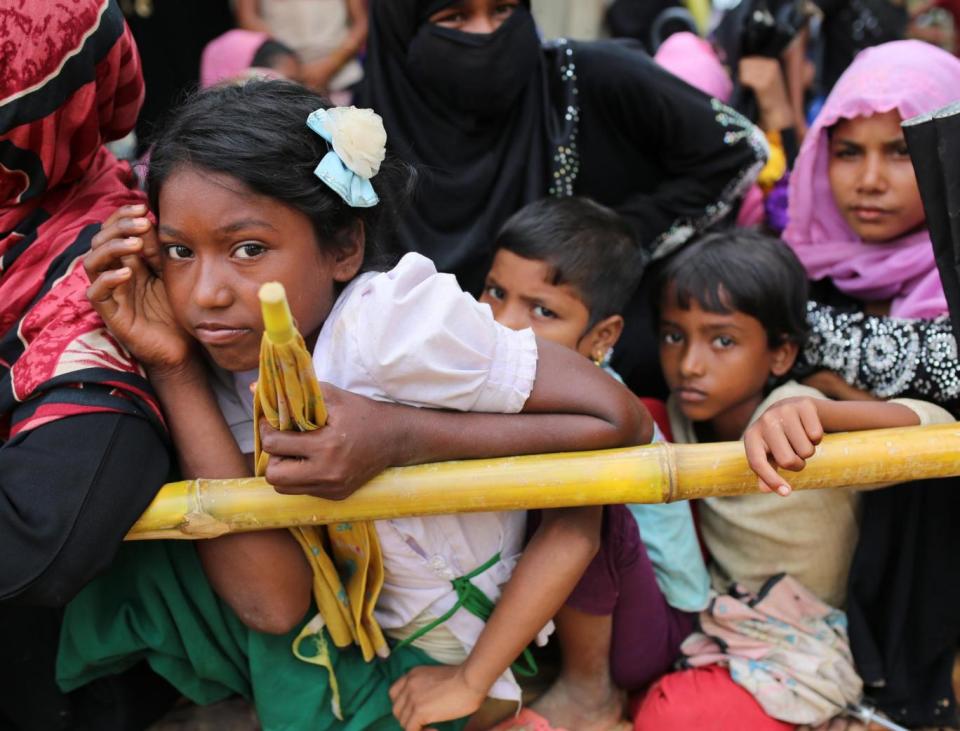 Rohingya children wait for food handouts at a refugee camp in Cox's Bazar, Bangladesh (AP)