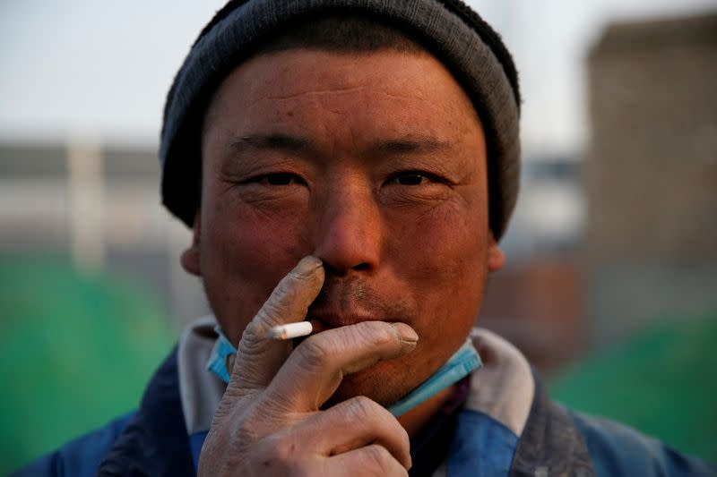 The Wider Image: 'I've let them down': Beijing's migrant workers miss family reunions on Lunar New Year