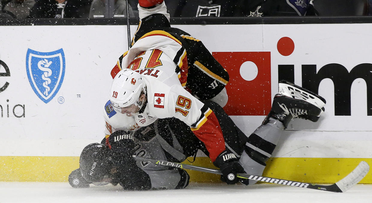 Los Angeles Kings defenseman Drew Doughty, bottom, upends Calgary Flames left wing Matthew Tkachuk, above, during the third period of an NHL hockey game in Los Angeles, Saturday, Oct. 19, 2019. (AP Photo/Alex Gallardo)