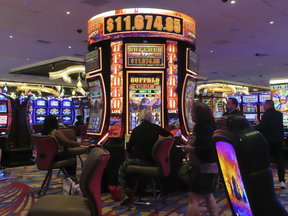 Gamblers play slot machines at the Hard Rock casino in Atlantic City N.J;. on Aug. 8, 2022. Figures released on Wednesday, Feb. 15, 2023 by the American Gaming Association show the U.S. commercial casino industry won over $60 billion from gamblers in 2022, its best year ever. (AP Photo/Wayne Parry)