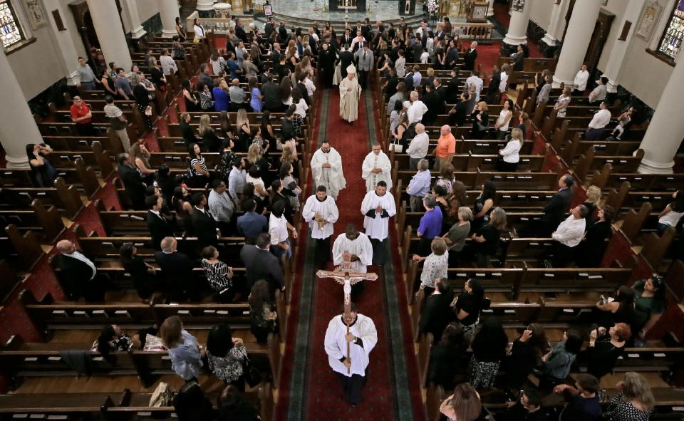 Family and friends of Andre Anchondo prepare to leave St. Patrick Cathedral in El Paso, Texas, following the funeral Mass for the father, who was killed in a racism-fueled attack at Walmart on Aug. 3, 2019.