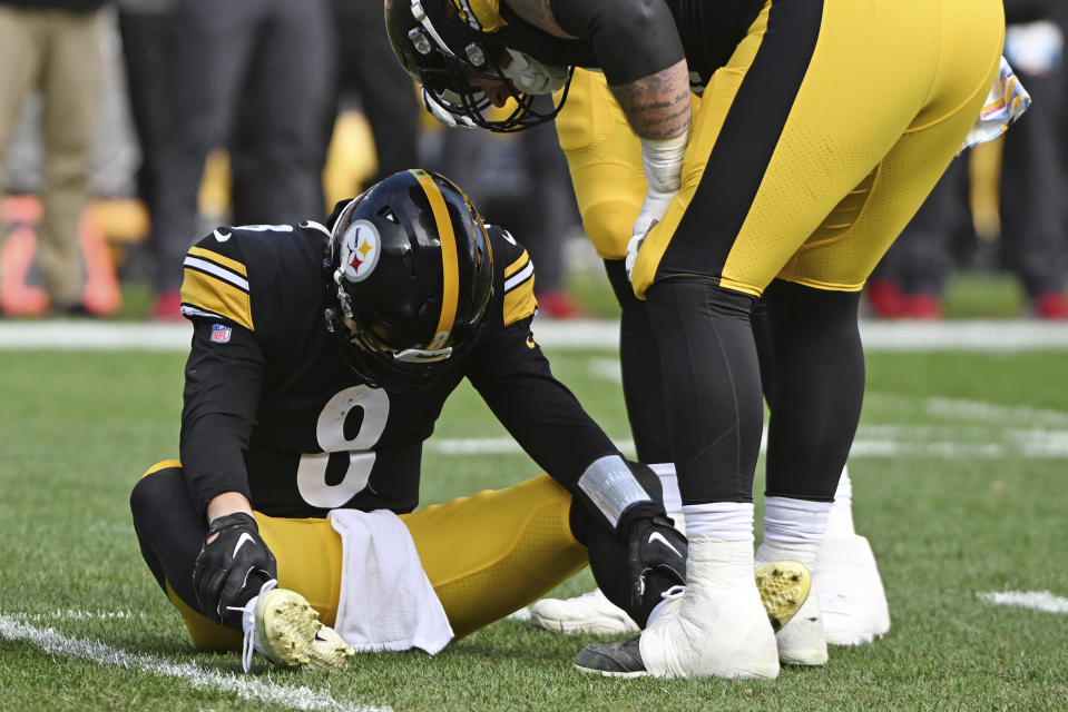 Pittsburgh Steelers quarterback Kenny Pickett (8) is helped on the field after being injured during the second half of an NFL football game against the Tampa Bay Buccaneers in Pittsburgh, Sunday, Oct. 16, 2022. (AP Photo/Barry Reeger)