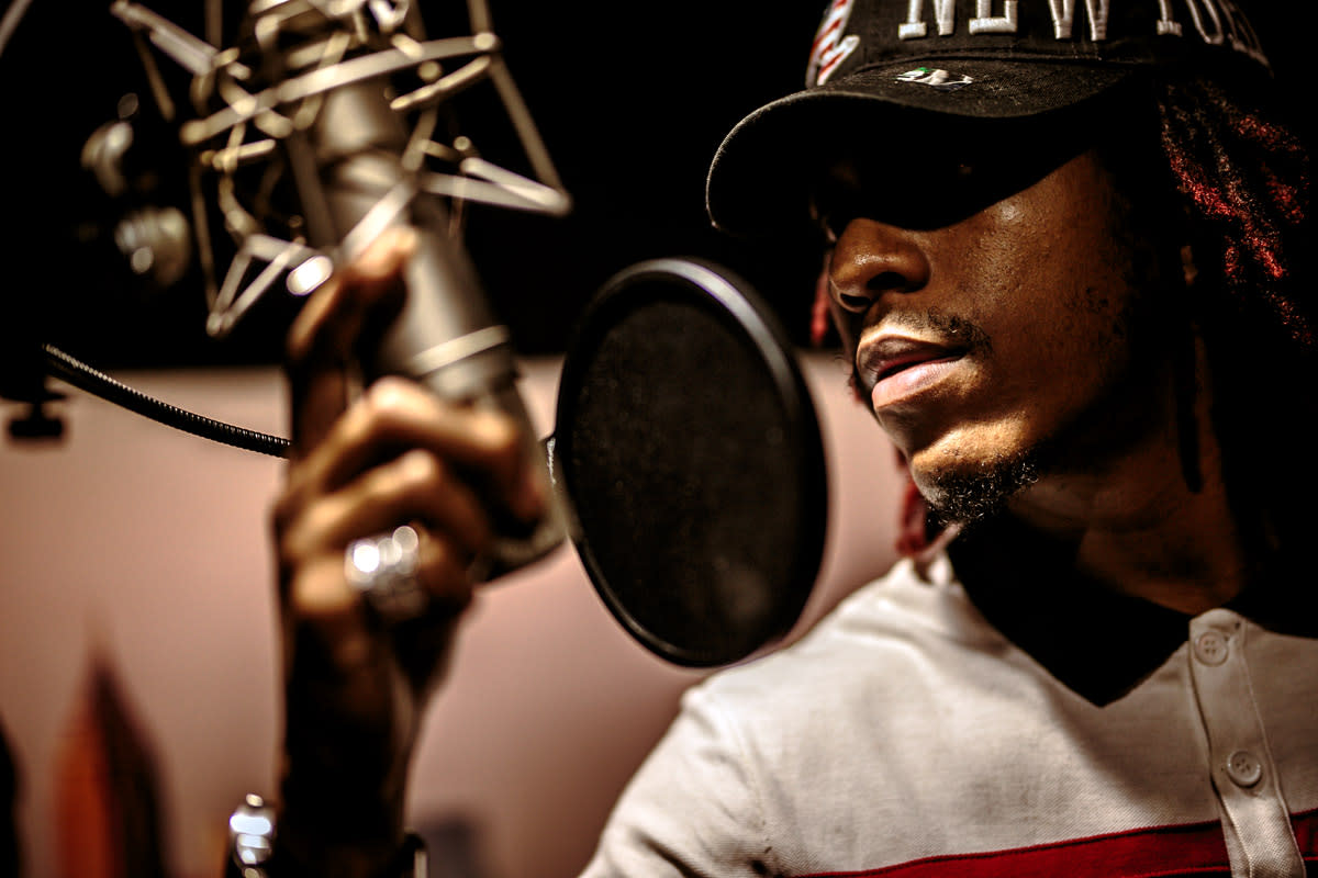 A rapper records in his studio.