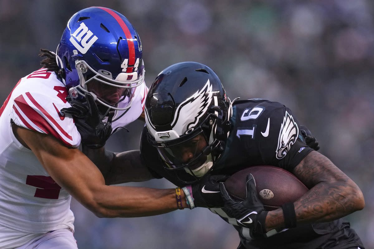 Quez Watkins runs with the ball against Nick McCloud.