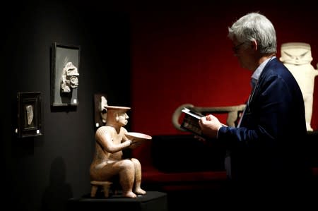 A female statue showing a dignitary, one of pre-Columbian artefacts, is presented to the press at Drouot auction house in Paris