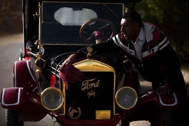 A mechanic wipes a 1924 Ford T which once belonged to Egypt’s King Farouk