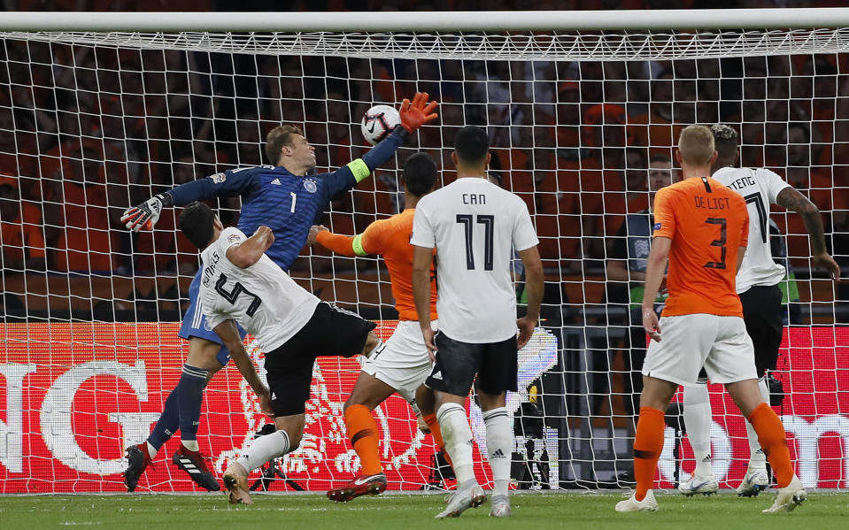 Netherland's Virgil Van Dijk, center, heads the opening goal against Germany's keeper Manuel Neuer during the UEFA Nations League soccer match between The Netherlands and Germany at the Johan Cruyff ArenA in Amsterdam, Saturday, Oct. 13, 2018. (AP Photo/Peter Dejong)