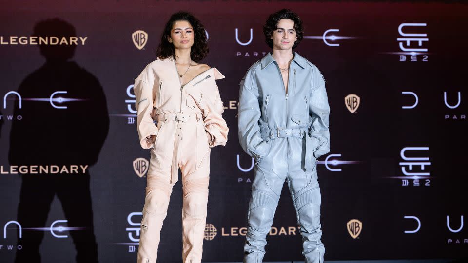 Zendaya and Chalamet — in matching boiler suits designed by Juun. J — attend a press conference in Seoul on February 21. - Anthony Wallace/AFP/Getty Images