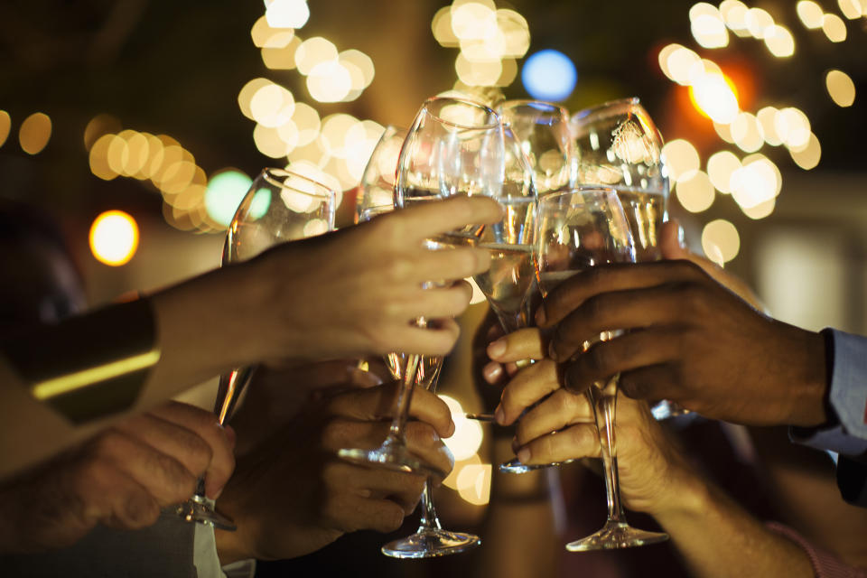A group of people toast with wine glasses.