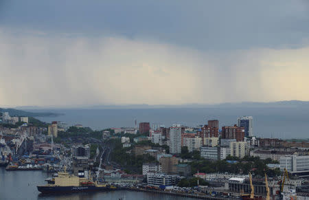 FILE PHOTO:Rain clouds pass over a commercial port in Vladivostok, Russia, June 8, 2017. REUTERS/Yuri Maltsev/File Photo