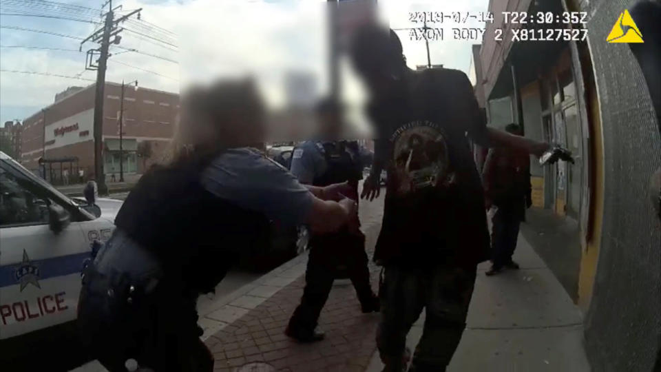 <p>Chicago Police attemps to grab Harith Augustus, 37, who fatally shot by police moments later, in this still image from police body camera video footage taken in Chicago, Ill., on July 14, 2018 and released on July 15, 2018. (Photo: courtesy Chicago Police Department/Handout via Reuters) </p>