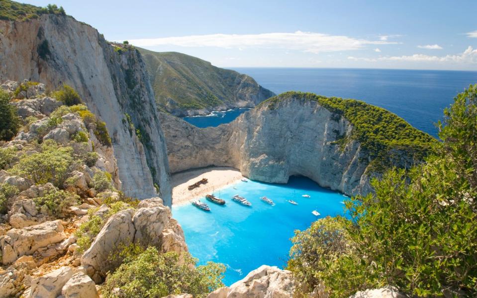 view of blue water and boats from above, big cliffs - David C Tomlinson/ The Image Bank RF