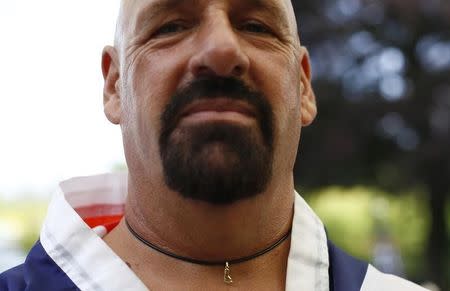 Alan "Nasty" Nash wears a necklace with a foot during the World Toe Wrestling championships in Ashbourne, central England June 8, 2013. REUTERS/Darren Staples