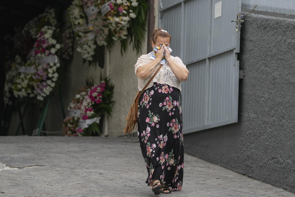 FILE - A woman greives during the funeral of seven-year-old Larissa Maia Toldo, who was killed by a man with a hatchet inside a day care center, at the Sao Jose cemetery, in Blumenau, Santa Catarina state, Brazil, April 6, 2023. Brazil is grappling with a wave of violence in its schools. The government has sought input from independent researchers and convened a meeting on Tuesday, April 18, 2023, of ministers, mayors and Supreme Court justices to discuss possible solutions. (AP Photo/Andre Penner, File)