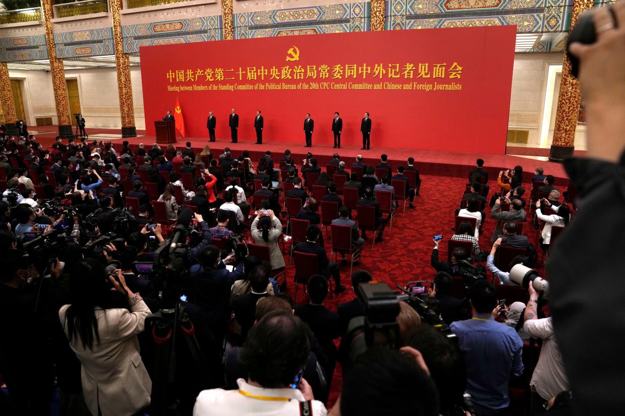 Chinese President Xi Jinping speaks at event to introduce new members of the Politburo Standing Committee, from left, Li Xi, Cai Qi, Zhao Leji, Li Qiang, Wang Huning, and Ding Xuexiang at the Great Hall of the People in Beijing, Sunday, Oct. 23, 2022. 