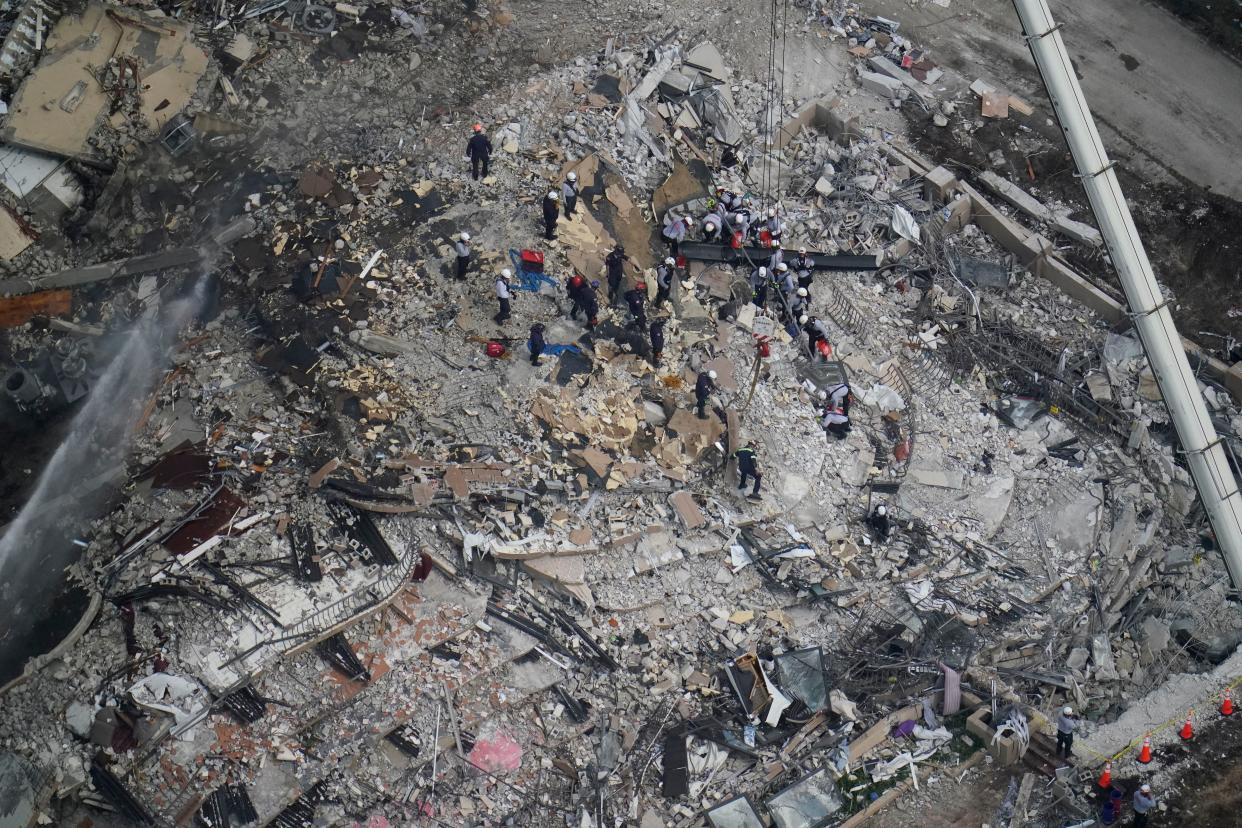 Workers search in the rubble at the Champlain Towers South Condo, Saturday, June 26, 2021, in Surfside, Fla. 159 people were still unaccounted for two days after Thursday's collapse, which killed at least four. (AP Photo/Gerald Herbert)