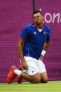 Jo-Wilfried Tsonga of France grimaces after taking a fall during the Men's Singles Tennis match against Thomaz Bellucci of Brazil on Day 2 of the London 2012 Olympic Games at the All England Lawn Tennis and Croquet Club in Wimbledon on July 29, 2012 in London, England. (Photo by Clive Brunskill/Getty Images)