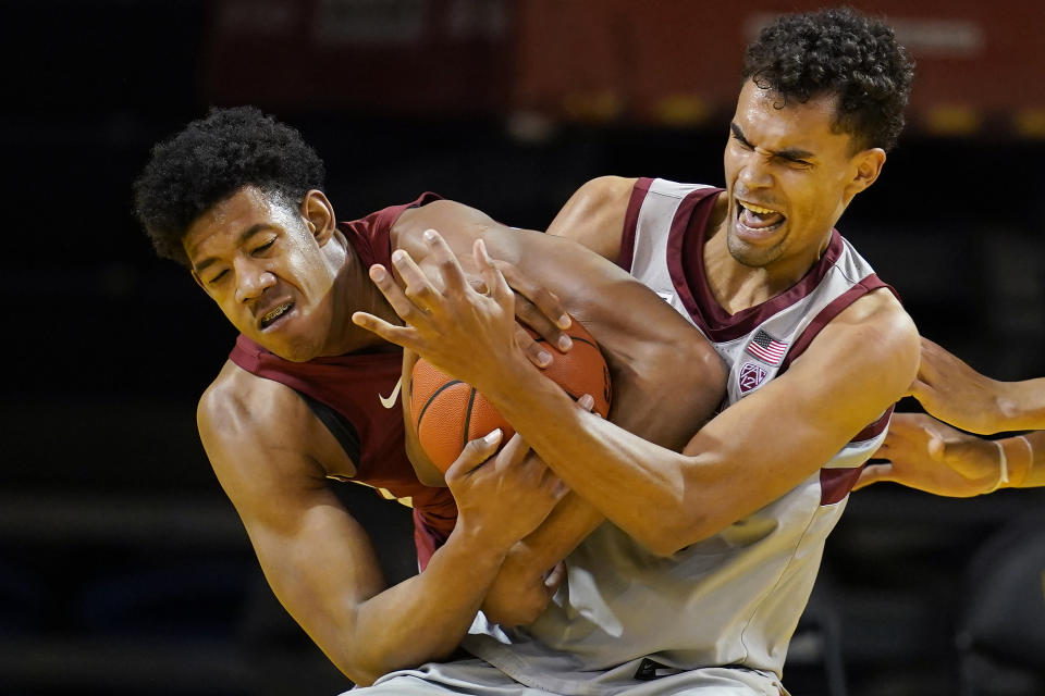 Washington State center Dishon Jackson, left, wrestles for the ball with Stanford forward Oscar da Silva during the second half of an NCAA college basketball game in Santa Cruz, Calif., Saturday, Jan. 9, 2021. (AP Photo/Jeff Chiu)