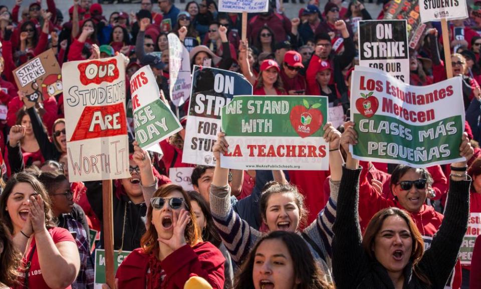 Educators, parents, students, and supporters of the Los Angeles teachers strike cheer in Grand Park on 22 January.