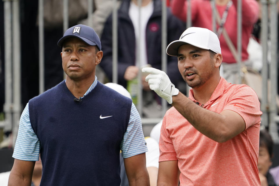 Jason Day of Australia, right, talks with Tiger Woods of the United States, left, on the first hole during the Challenge: Japan Skins event ahead of the Zozo Championship PGA Tour at Accordia Golf Narashino C.C. in Inzai, east of Tokyo, Monday, Oct. 21, 2019. (AP Photo/Lee Jin-man)