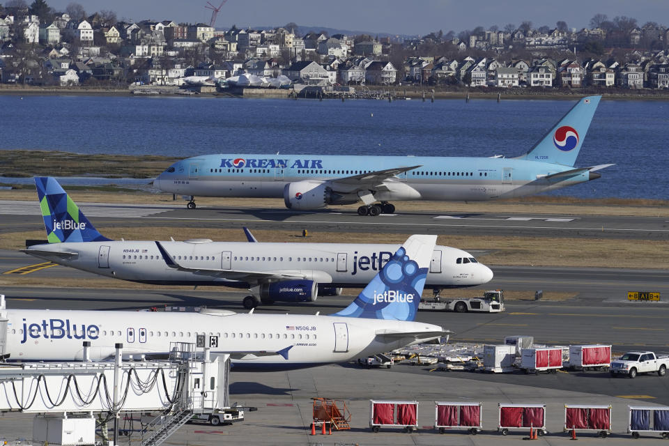 Passenger jets are seen on the tarmac at Logan International Airport, Jan. 11, 2023, in Boston. Thousands of flight delays and cancellations rippled across the U.S. early Wednesday after computer outage led to a grounding order by the Federal Aviation Administration. (AP Photo/Steven Senne)