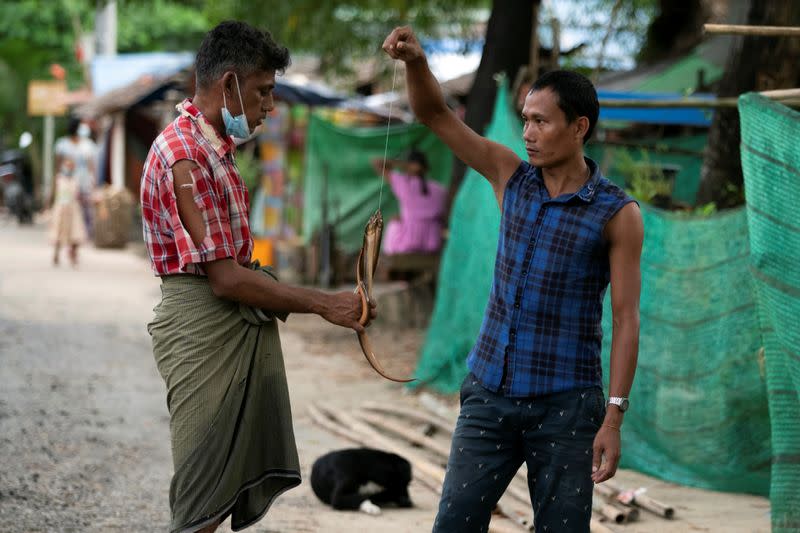 Man selling eels in Yangon slum during coronavirus lockdown