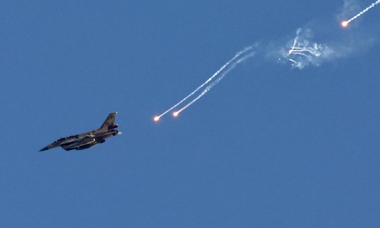 <span>An Israeli fighter jet ejects flares over an area near the Lebanon-Israel border.</span><span>Photograph: Atef Safadi/EPA</span>